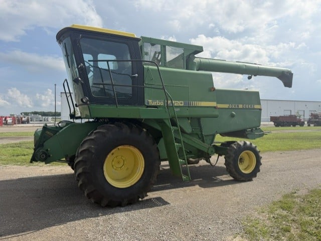 John Deere 7720 Turbo combine harvester parked on paved lane